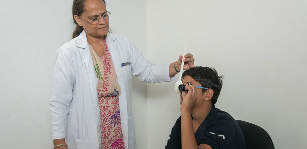 Patient undergoing low vision evaluation and refraction testing at Raghudeep Eye Hospital