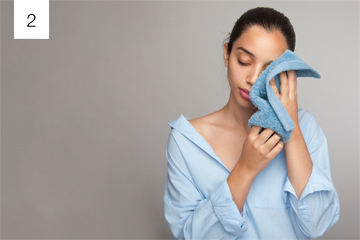 Person rubbing eyes with hands causing irritation and stye risks