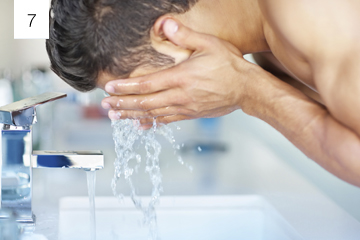 Man splashing water to clean dust from around the eyes